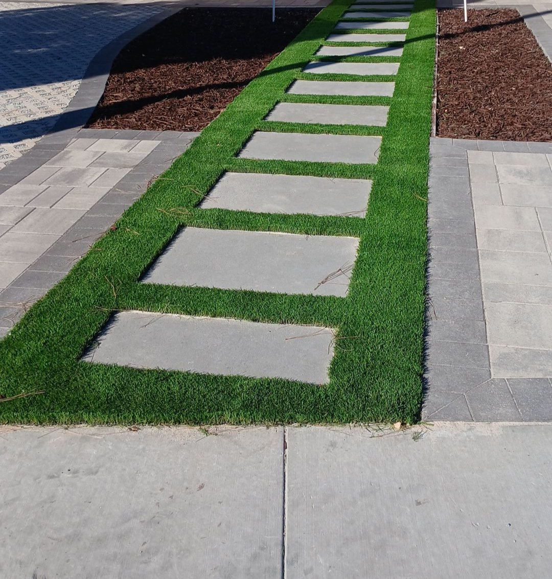 Artificial turf walkway with concrete stepping stones