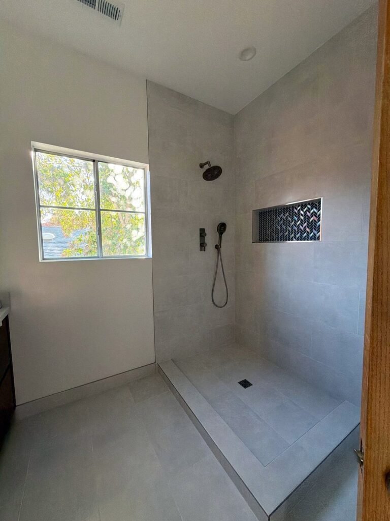 Low-curb walk-in shower with handheld shower and niche, Los Gatos