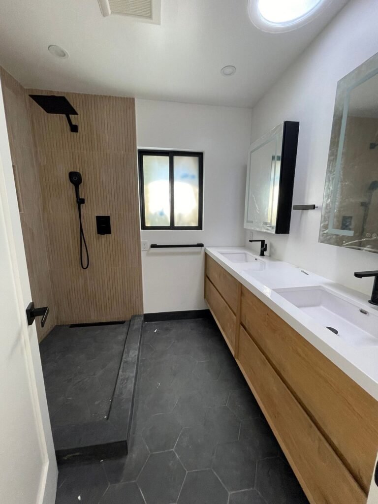 Walk-in shower with linear drain next to a double vanity, Fremont