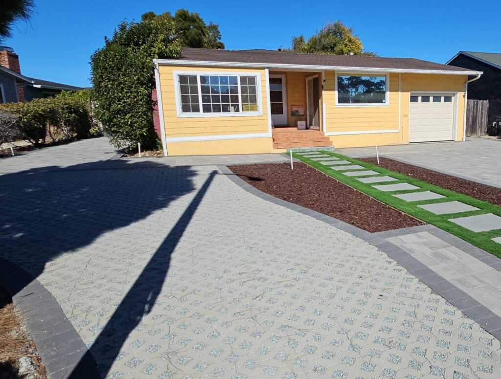 Front yard makeover with permeable paver driveway, artificial turf walkway with stepping stones and mulch beds