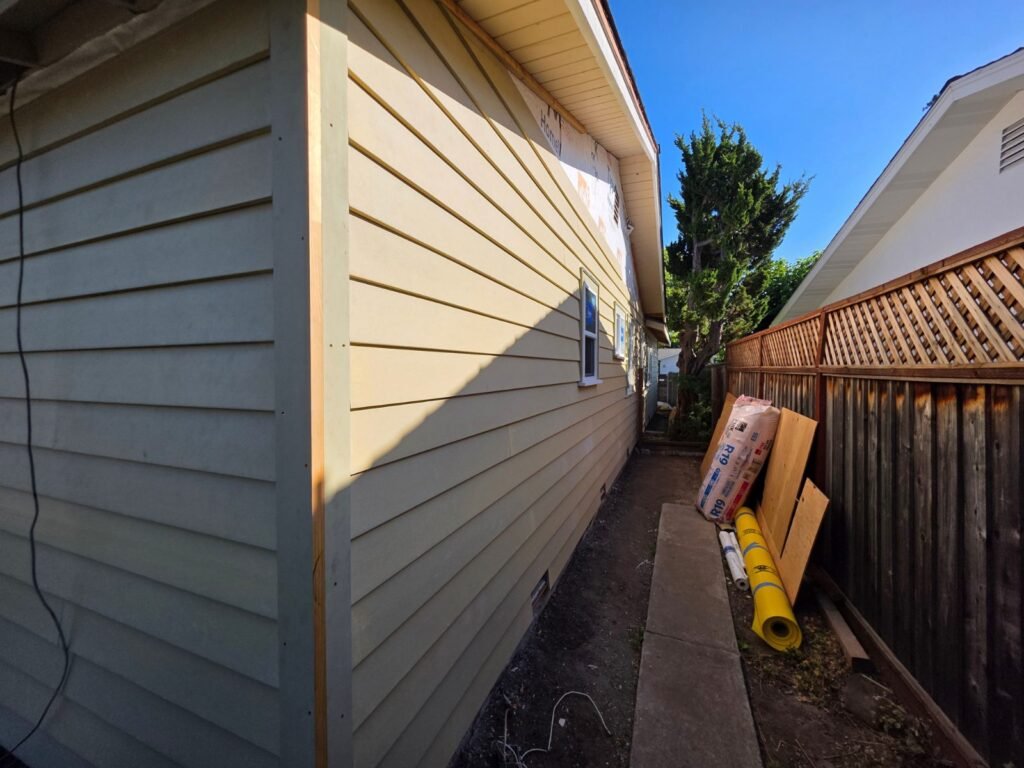 Newly installed horizontal lap siding along the side of a Bay Area home