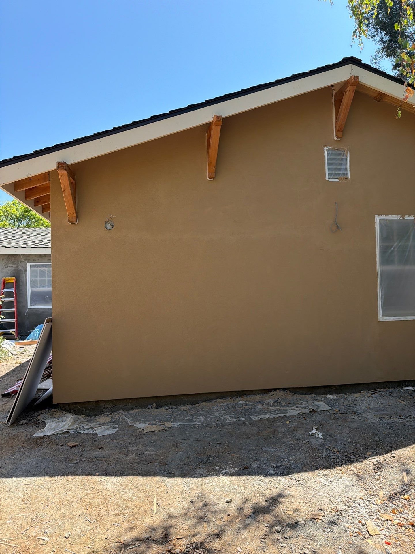 Backyard ADU in Los Altos with new stucco exterior and decorative rafter tails