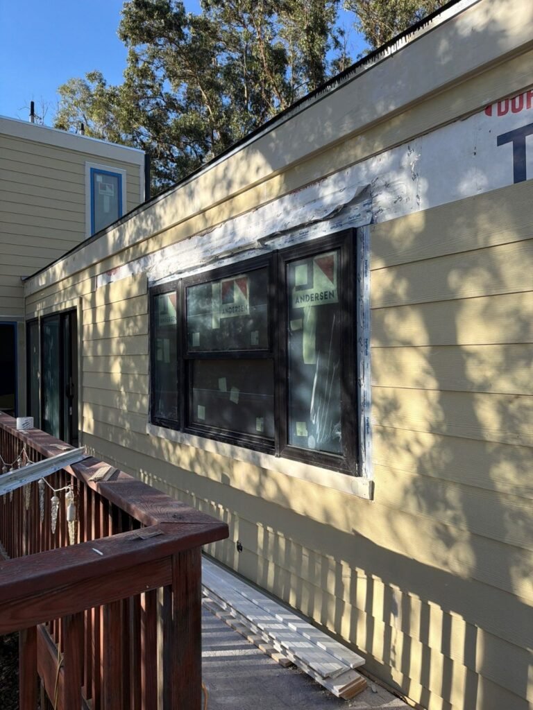 Window flashing tape and house wrap where new lap siding meets a replacement window